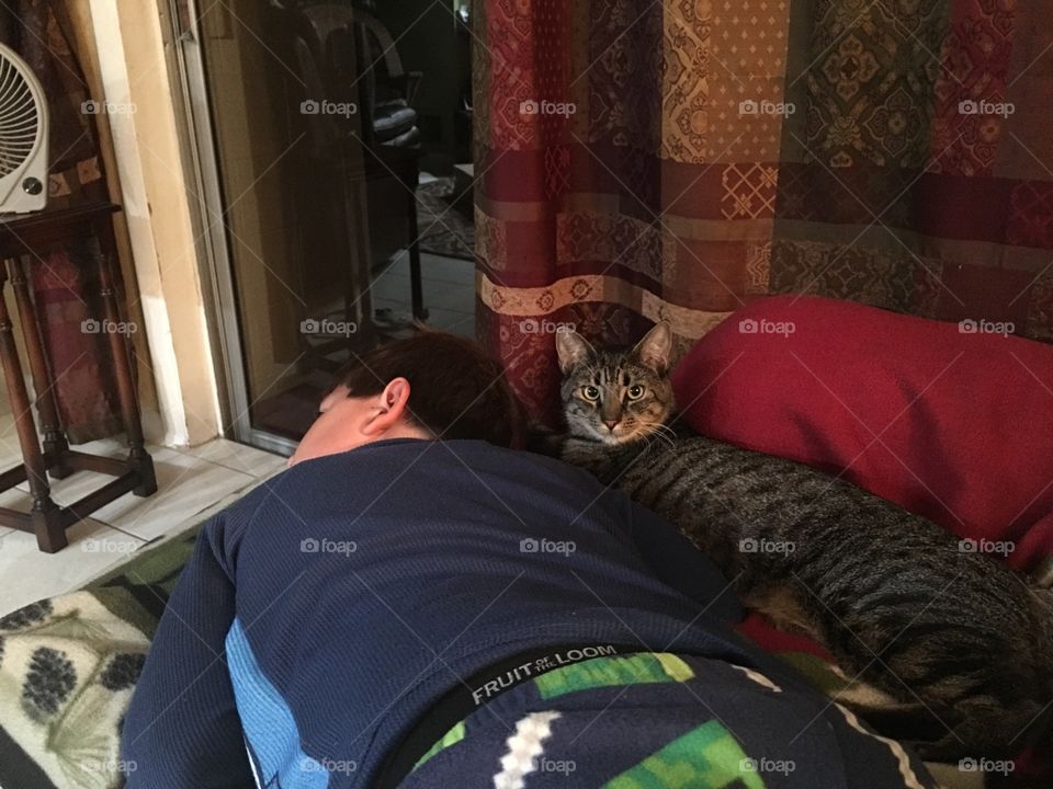 Cat sleeping with a boy