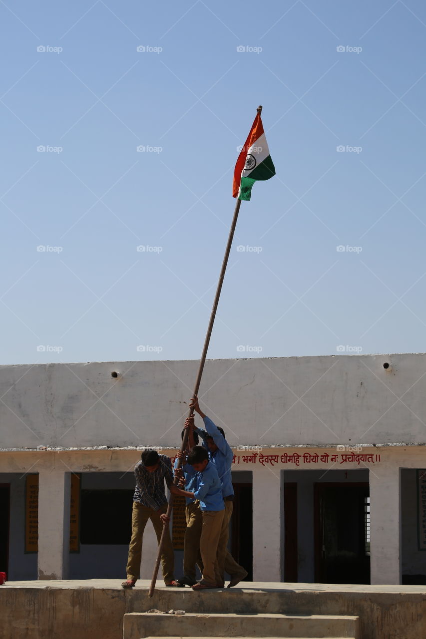 Students raising their countries flag at school.