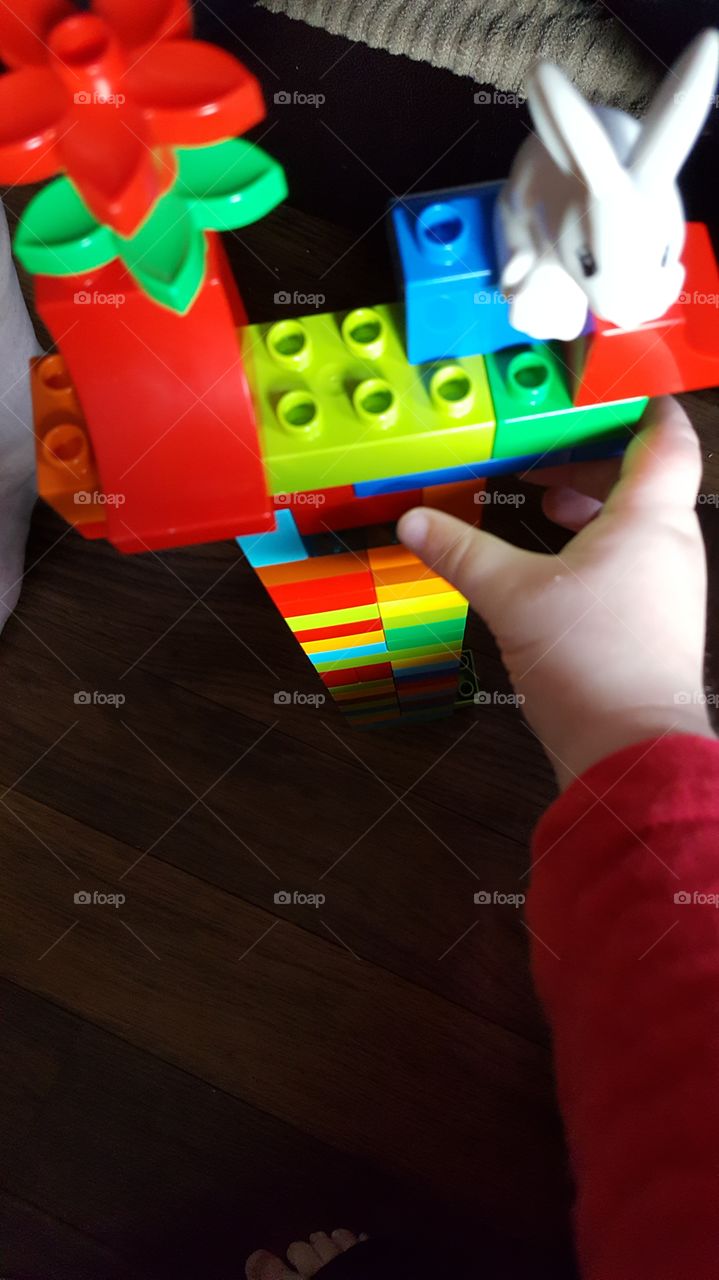 toddler playing with his legos
