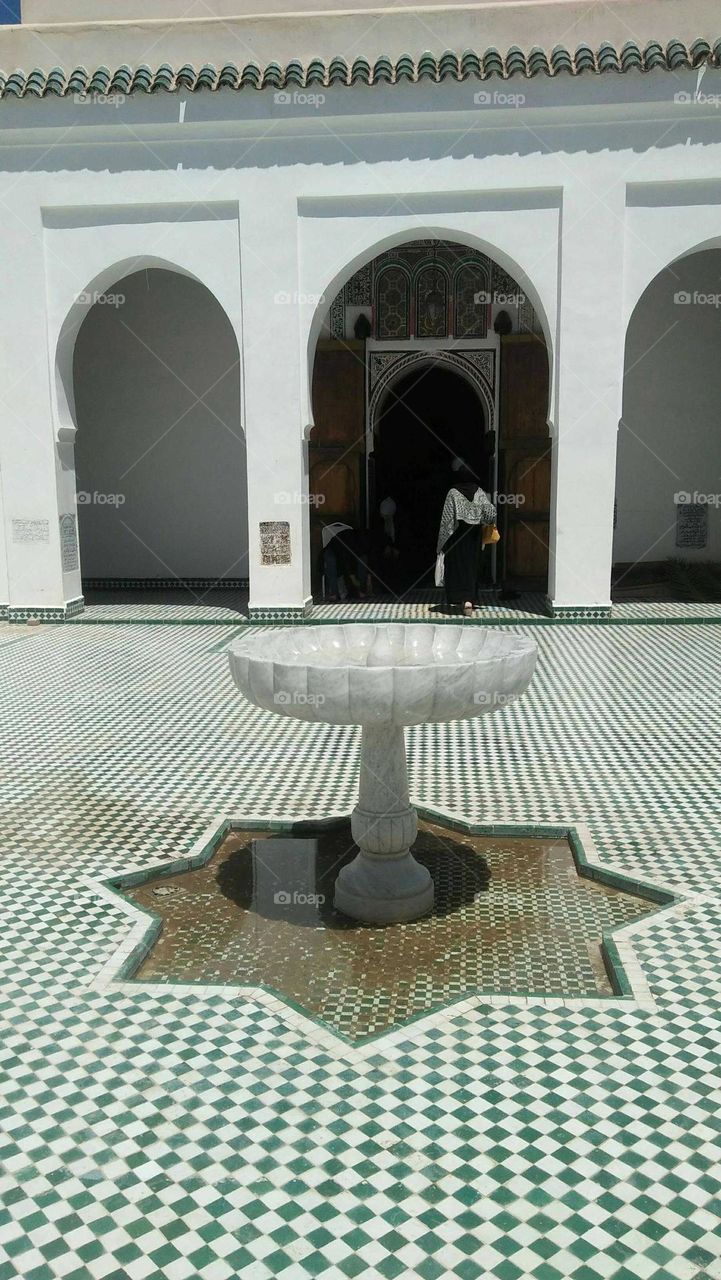 Beautiful fountain into ancient monument at marrakech city in Morocco.