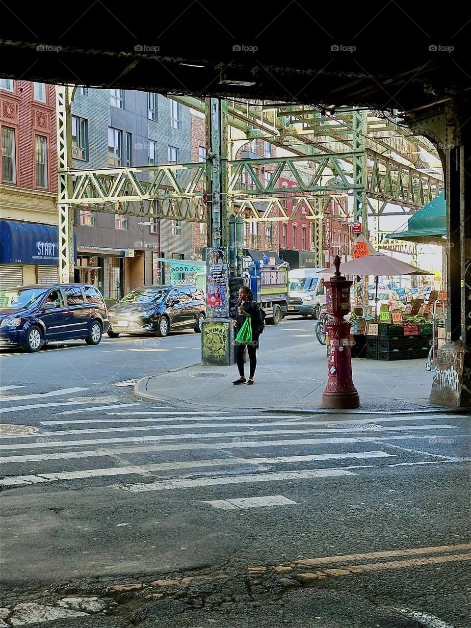 This is the MTA “M” train overpass at “Myrtle Avenue” and “Broadway” in “Bushwick”, Brooklyn, NY. Ceaseless traffic moves through this intersection day and night by the 24 hour Korean deli “Mr Kiwi”. 2024. Hypnotic Productions