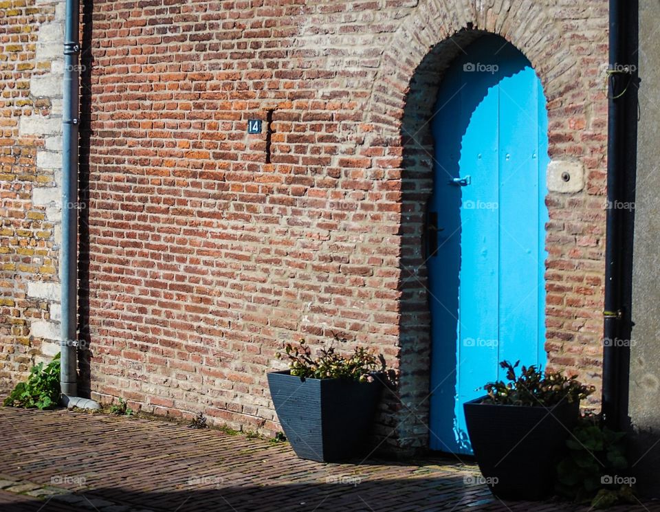 An aqua door on a brick house in Zouteland, Netherlands. 