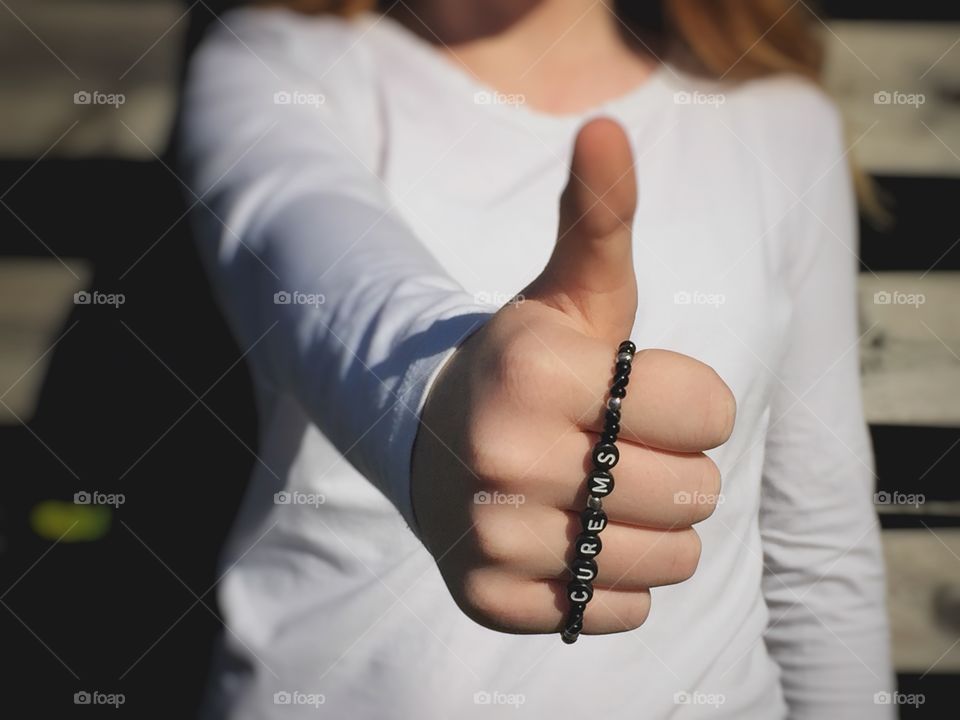 Young girl showing thumb-up