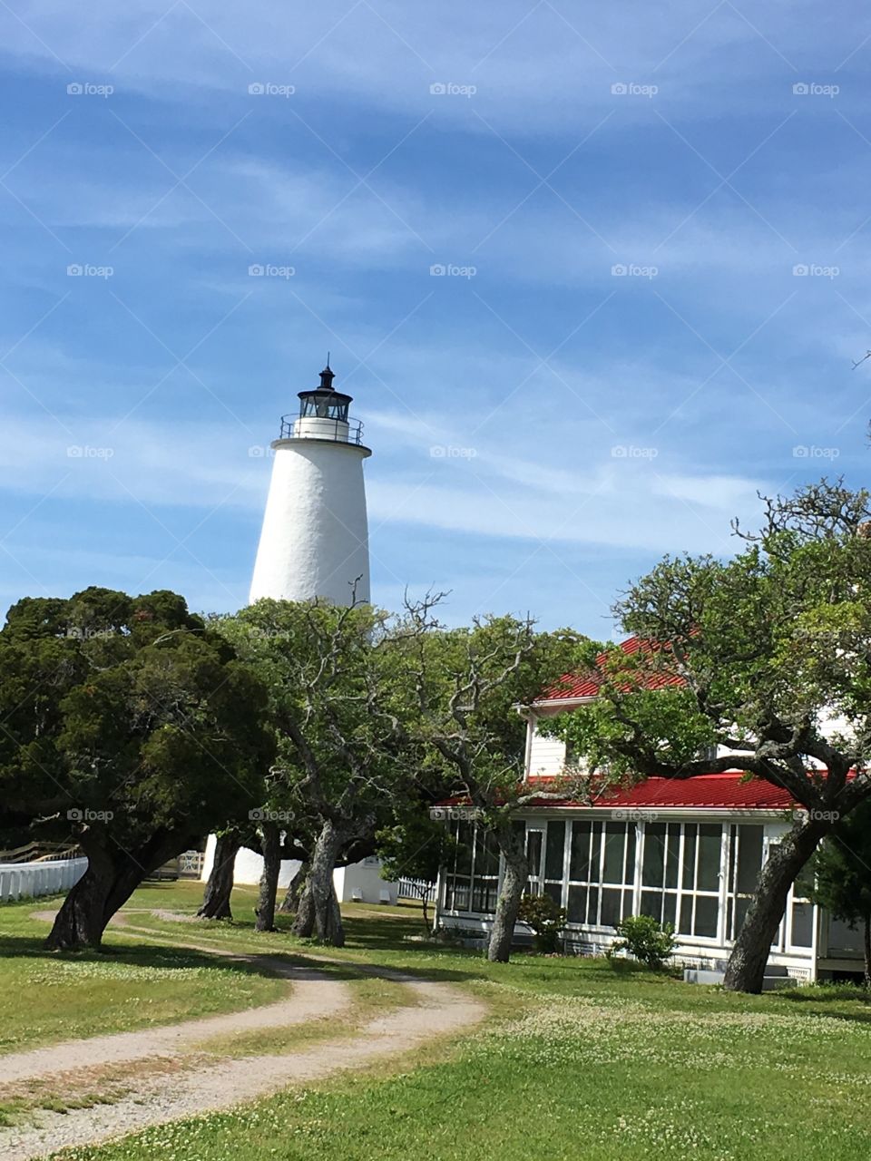 Lighthouse at Ocracoke Inlet, NC with lighthouse keepers residence on the right.