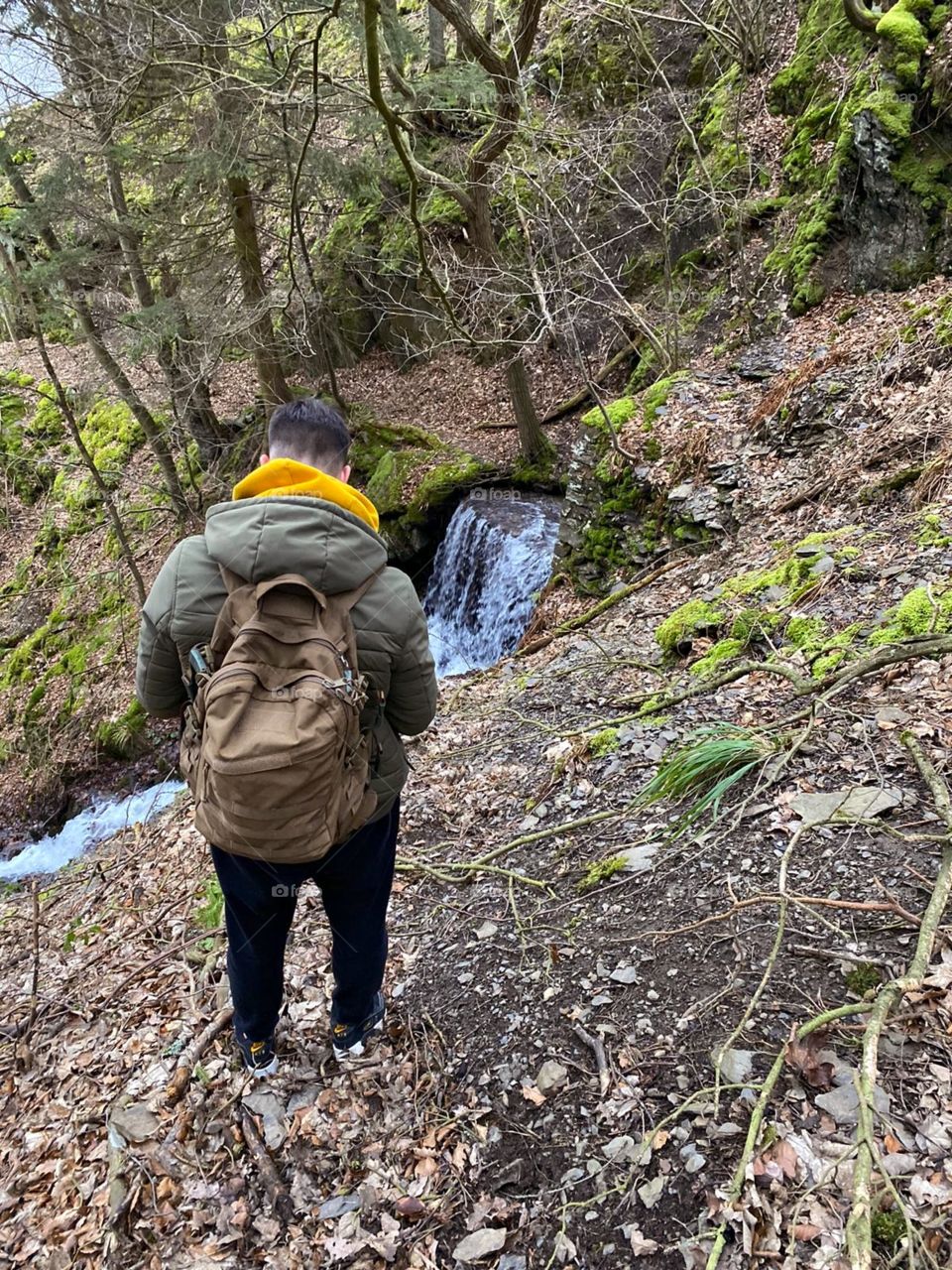 Hiking man though the woods