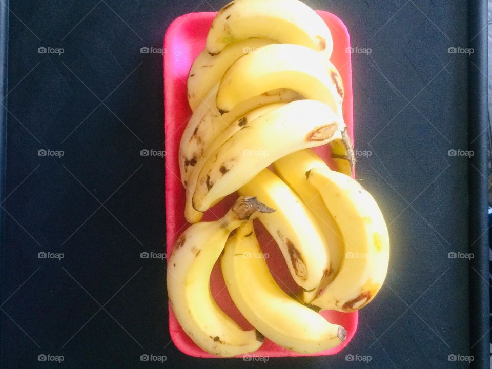 Ripe Bananas On A Pink Tray