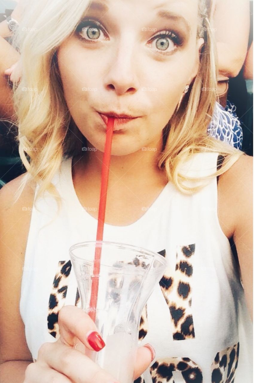 Pretty Blonde Drinking from Straw