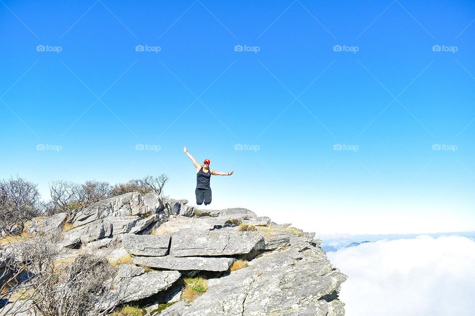 Jumping at the summit of hike