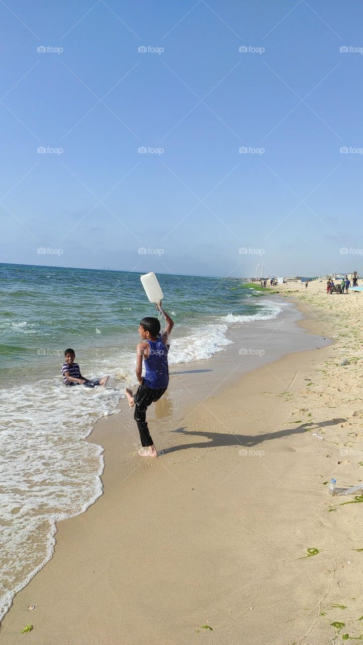 The child on the beach is playing happily