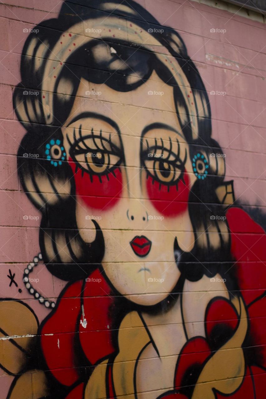 A closeup of some colourful artwork is on full display on the side of a building in a nearby village known for its vibrant public art.