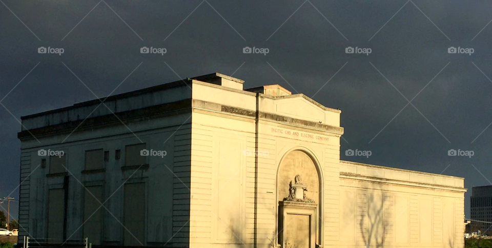 sun shining on an old building after a  weekend of stormy weather near Sacramento River.