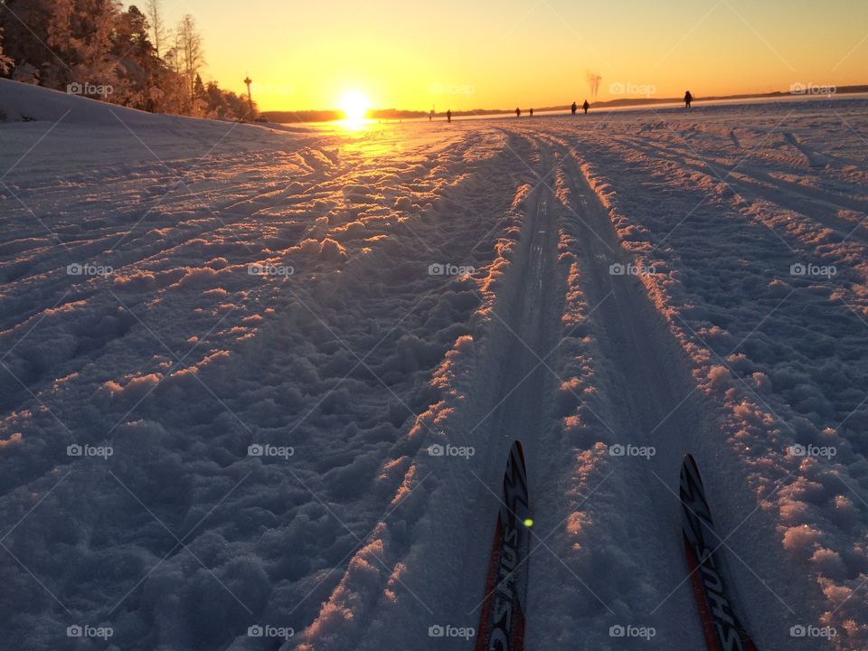 Cross country skiing on a Frozen lake in Sunset 