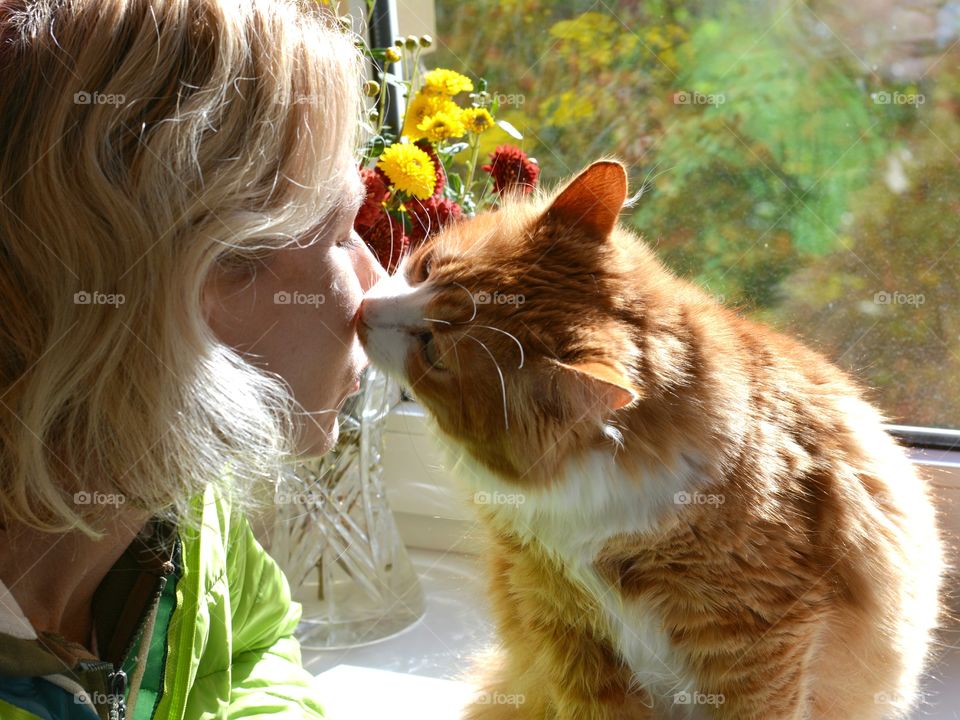 woman and ginger cat indoor family