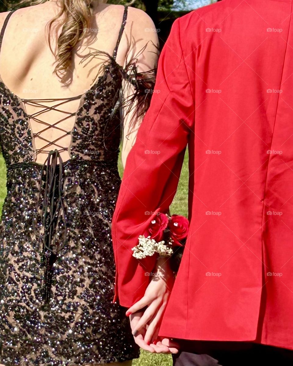 Young couple red jacket, black dress 