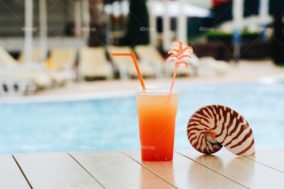 Close-up of cocktail near swimming pool