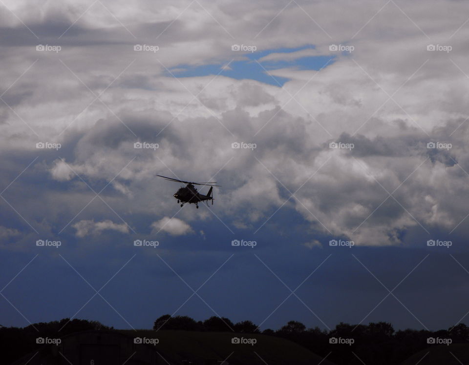 A helicopter against stormy sky