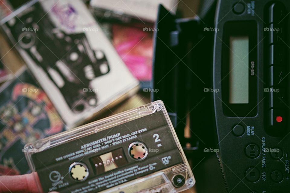 Playing cassette tapes at home, putting a cassette tape in a tape player, having fun at home, nostalgic things found in your home, focus on cassette tape, Aerosmith Cassette Tape, vintage music, retro music player, playing cassette tapes