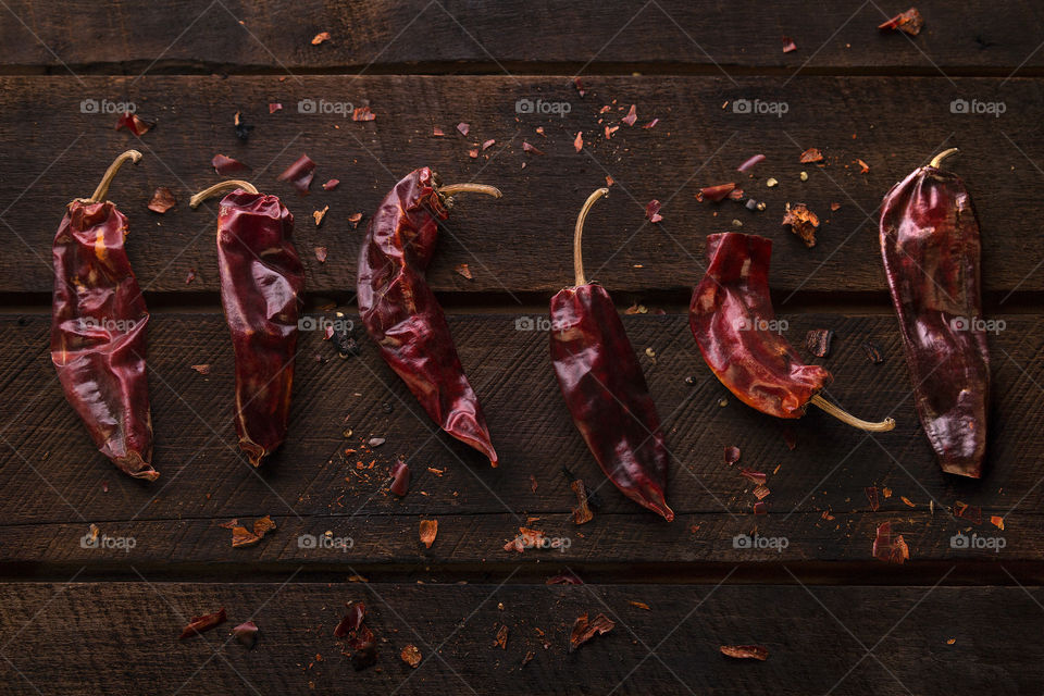 smoked peppers on rustic wood, red