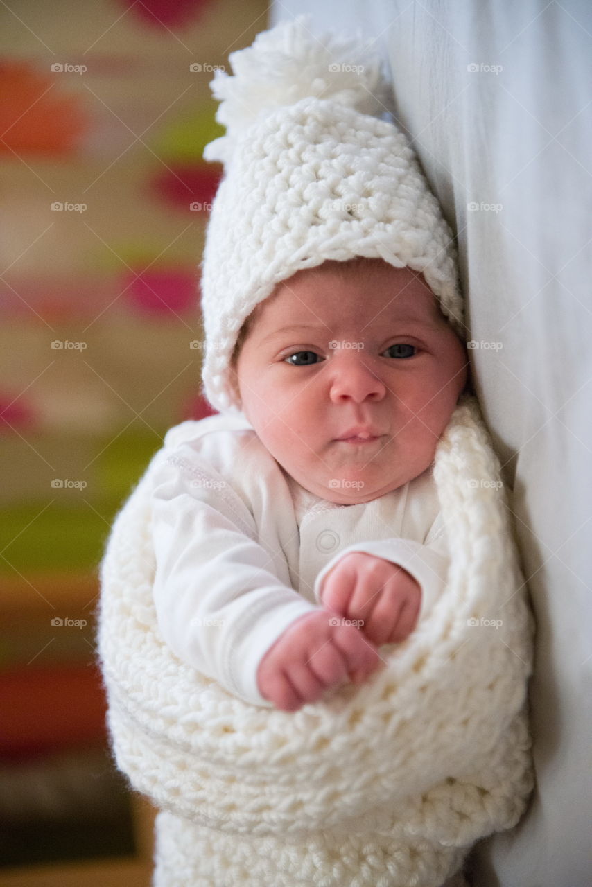 Newborn baby lying on bed