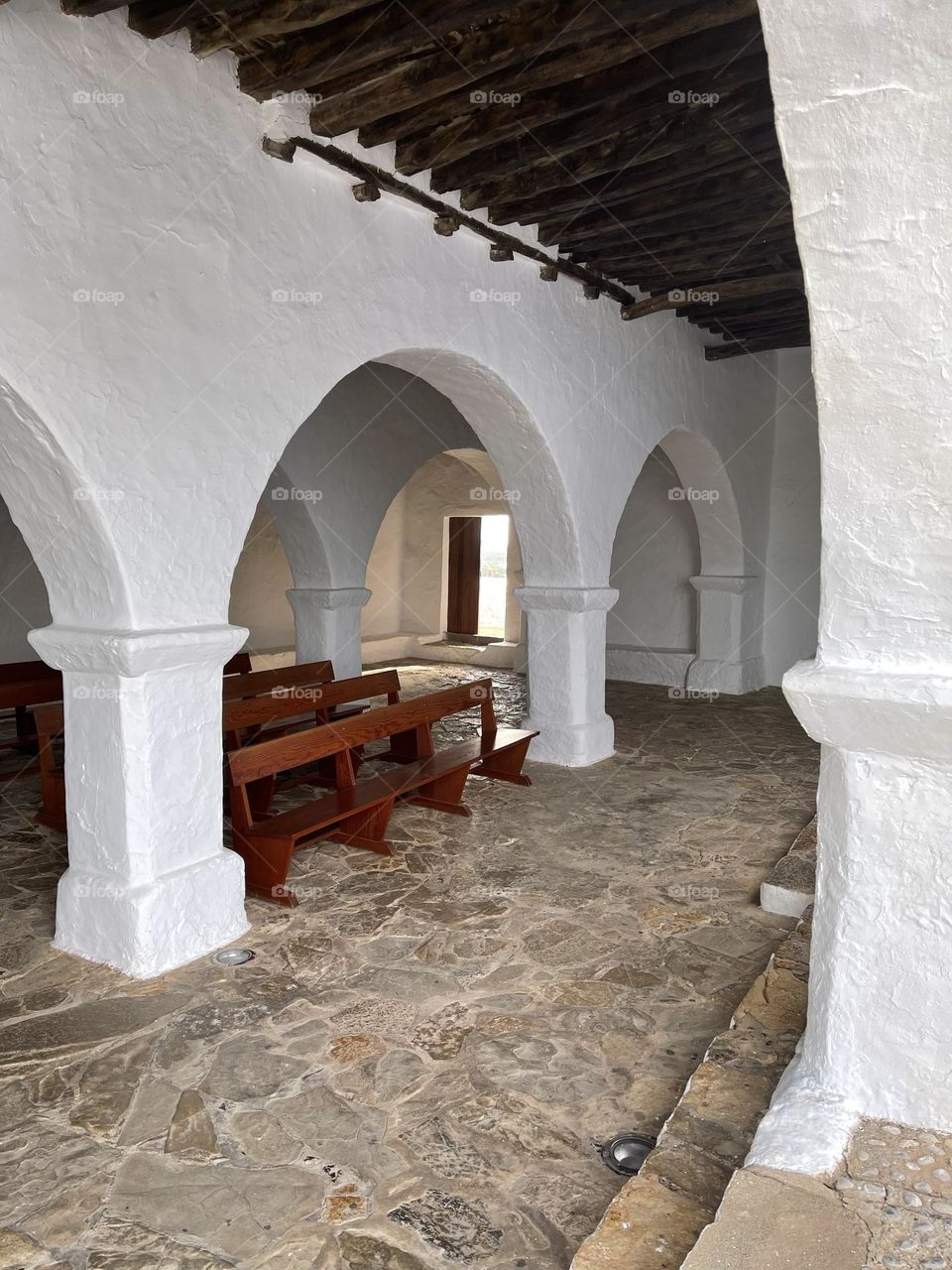 Arcades in a white washed church in Santa Eulalia, Ibiza, Spain 