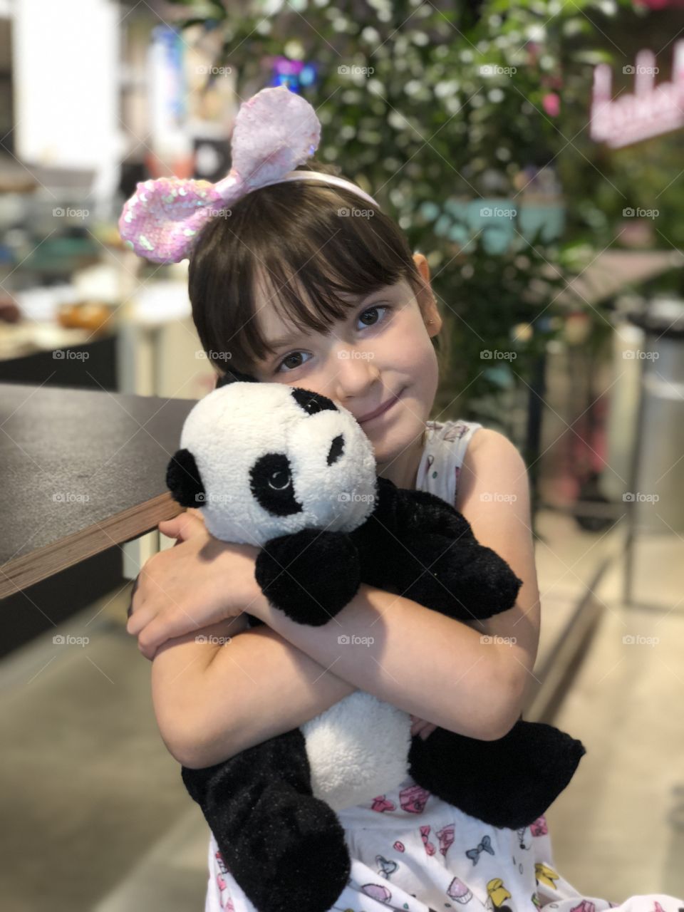 Little girl with plush panda 