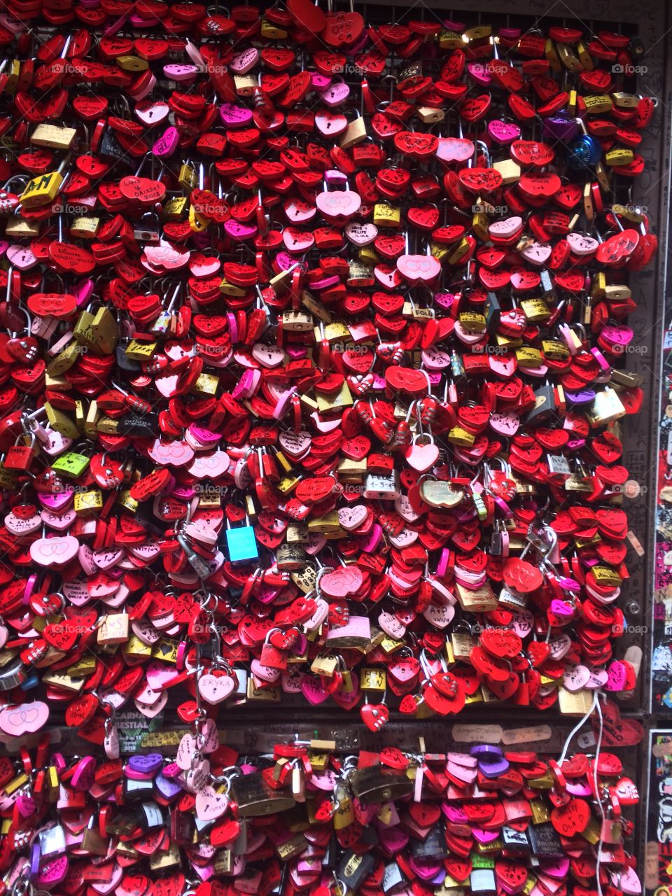 Lots of red and pinky locks symbolizing never ending love in Verona, Italy