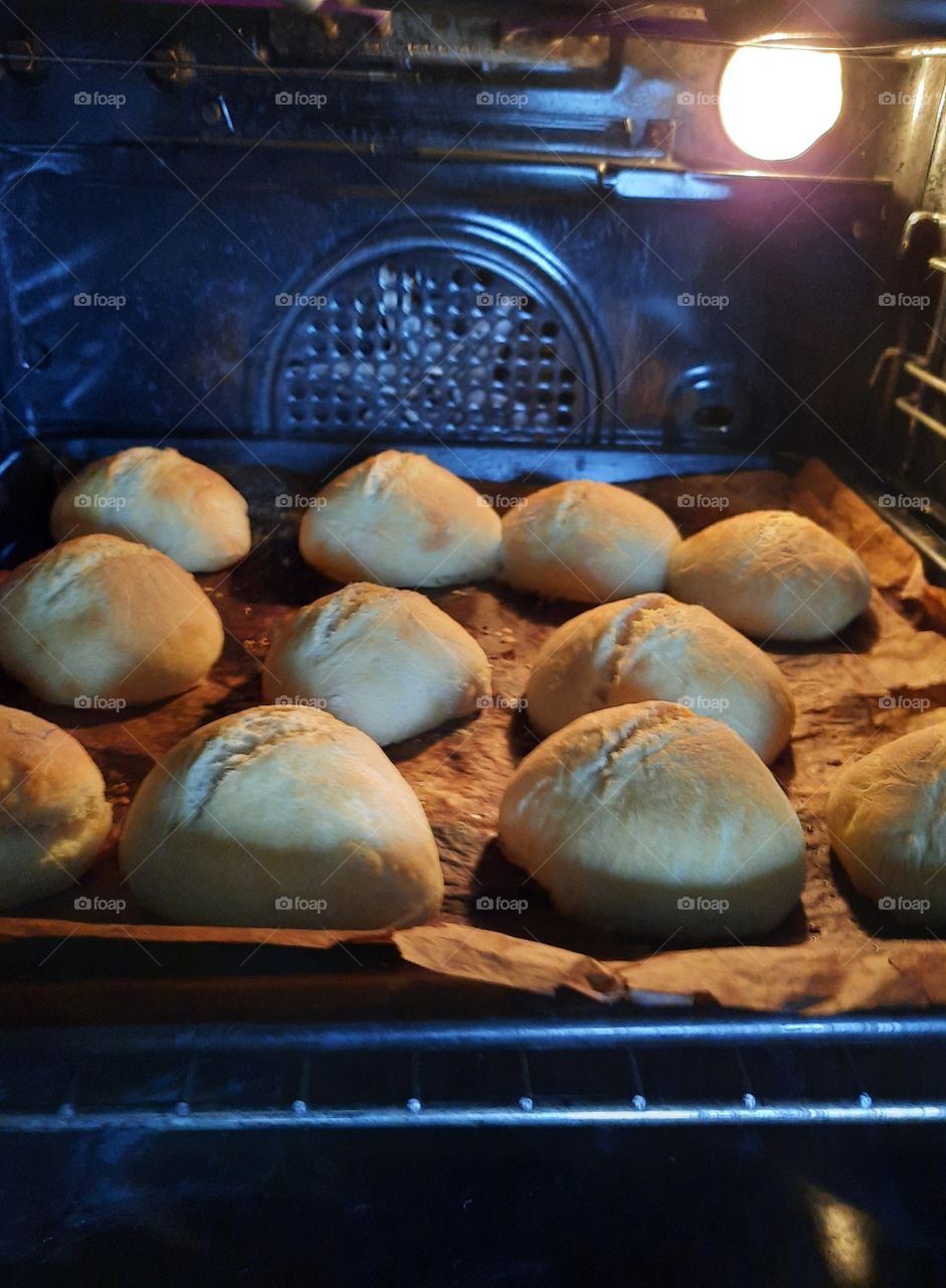 home made buns baked in the oven  illuminated by a bulb