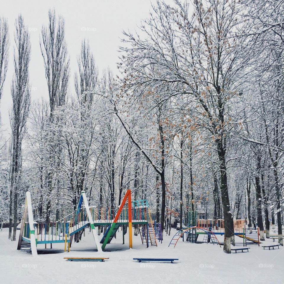 children playground in the snow