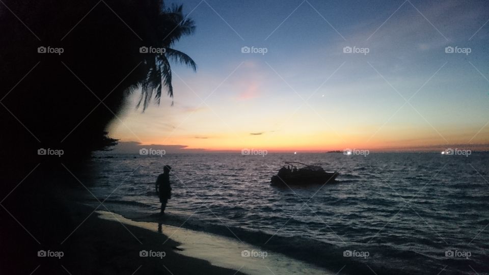 One of the natural beauty of the beach TOPENG BATU Java island, white sand and dusk are so charming, clear water on the beach and do not forget to prepare a bottle of beer