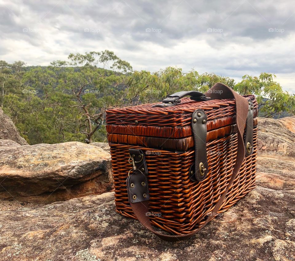 Picnic on a Rock- wicker picnic basket outdoors