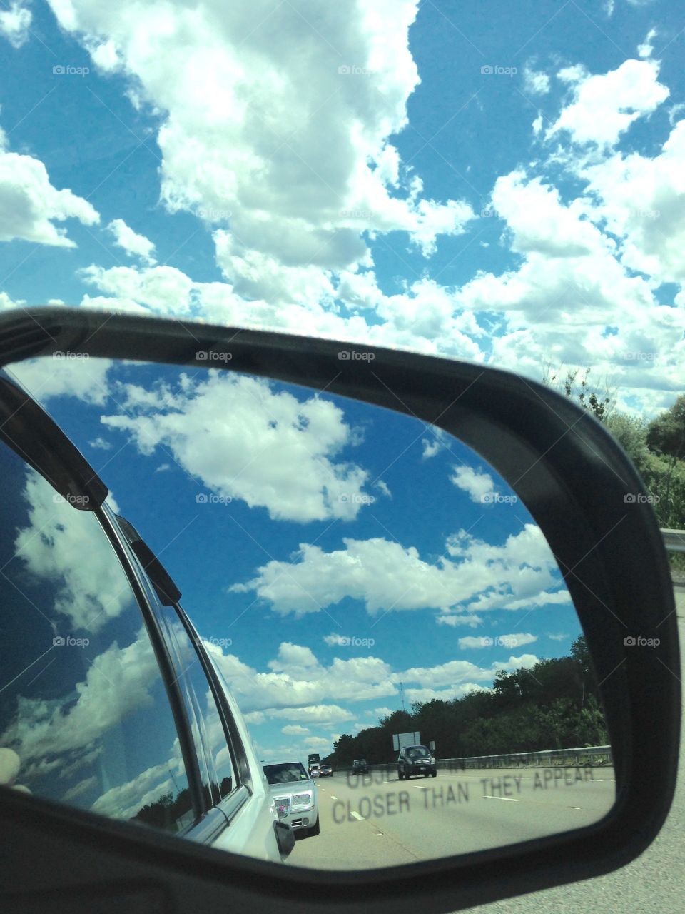 Rear View Mirror Clouds in Back & Front

In the SUV, all I saw was fluffy clouds in back of us and fluffy clouds in front of us! The blue sky was beautiful too!