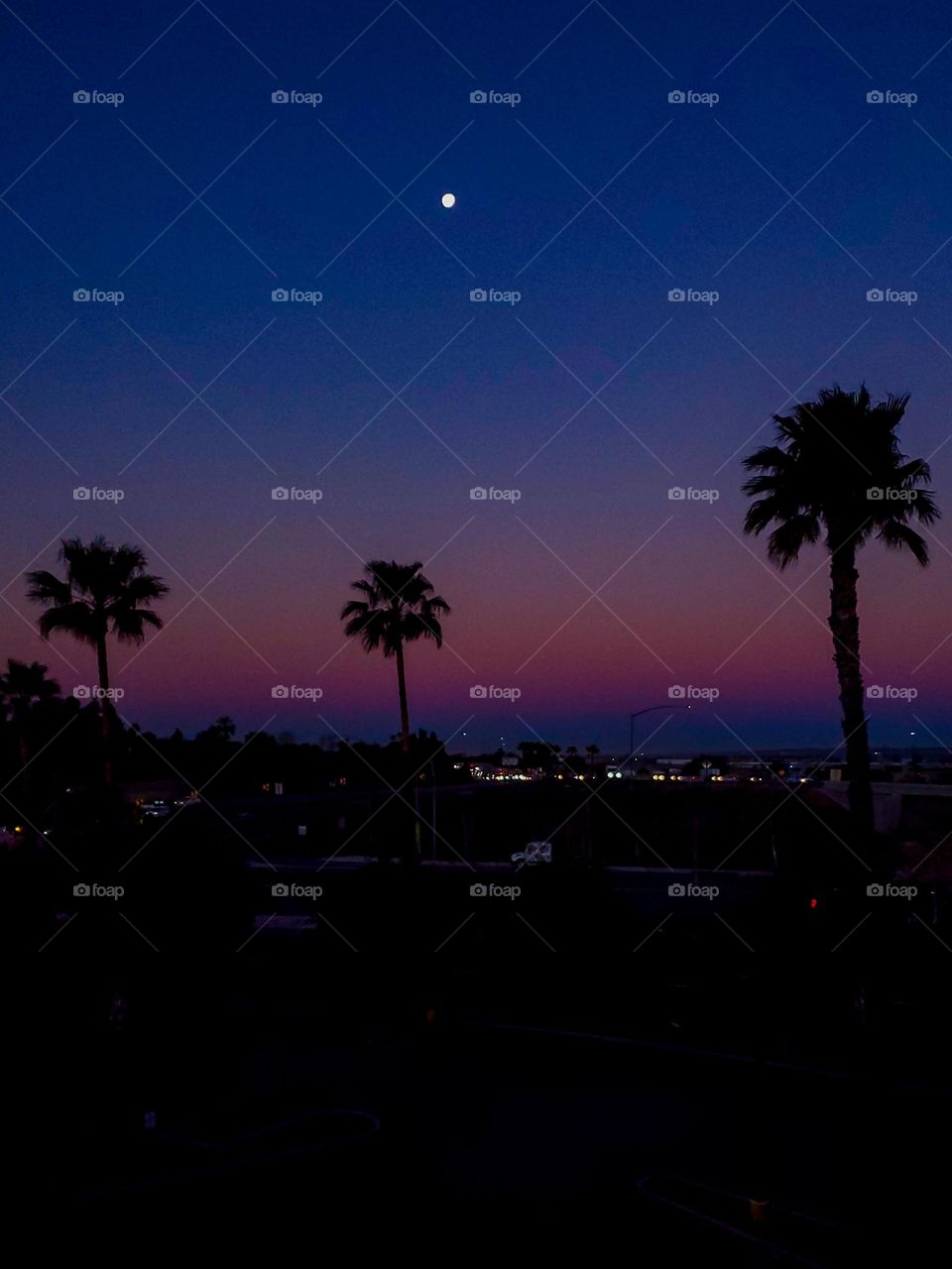 Early morning sunrise meets a setting moon on a Southern California morning
