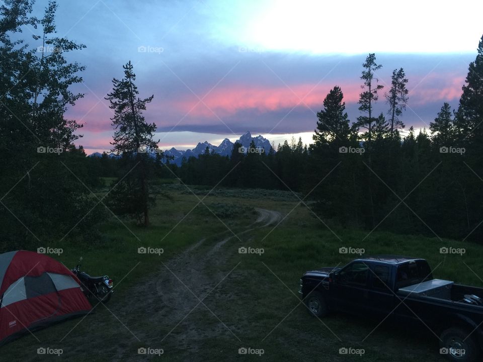Tent camping with the Grand Tetons at sunset. 
