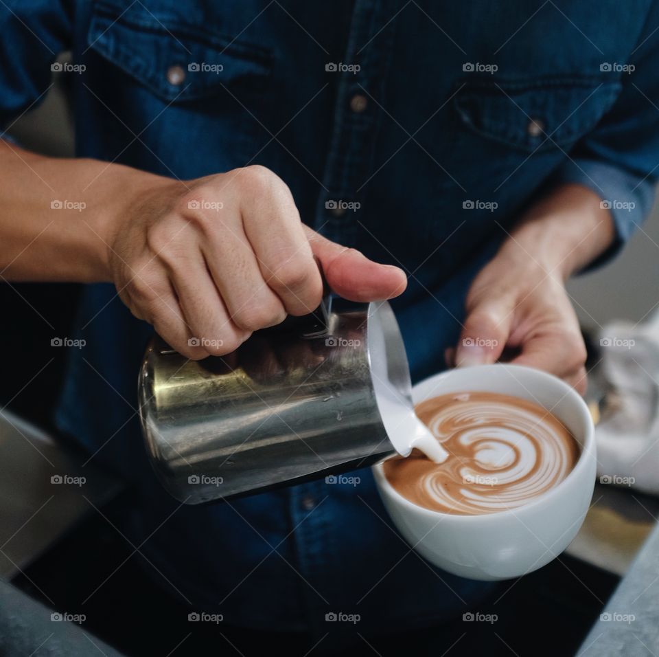 Barista pouring latte art