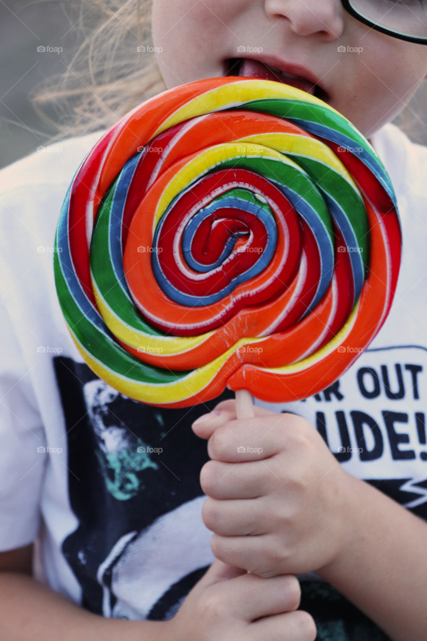 Child enjoying a large lollipop