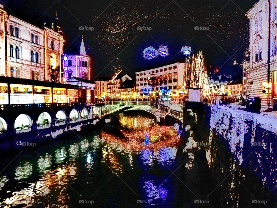 Triple Bridge and Ljubjanica River at night illuminated by Christmas lights in oldtown Ljubljana, Slovenia