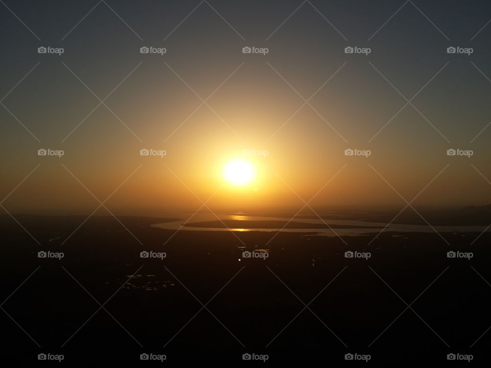 sun setting over a creek