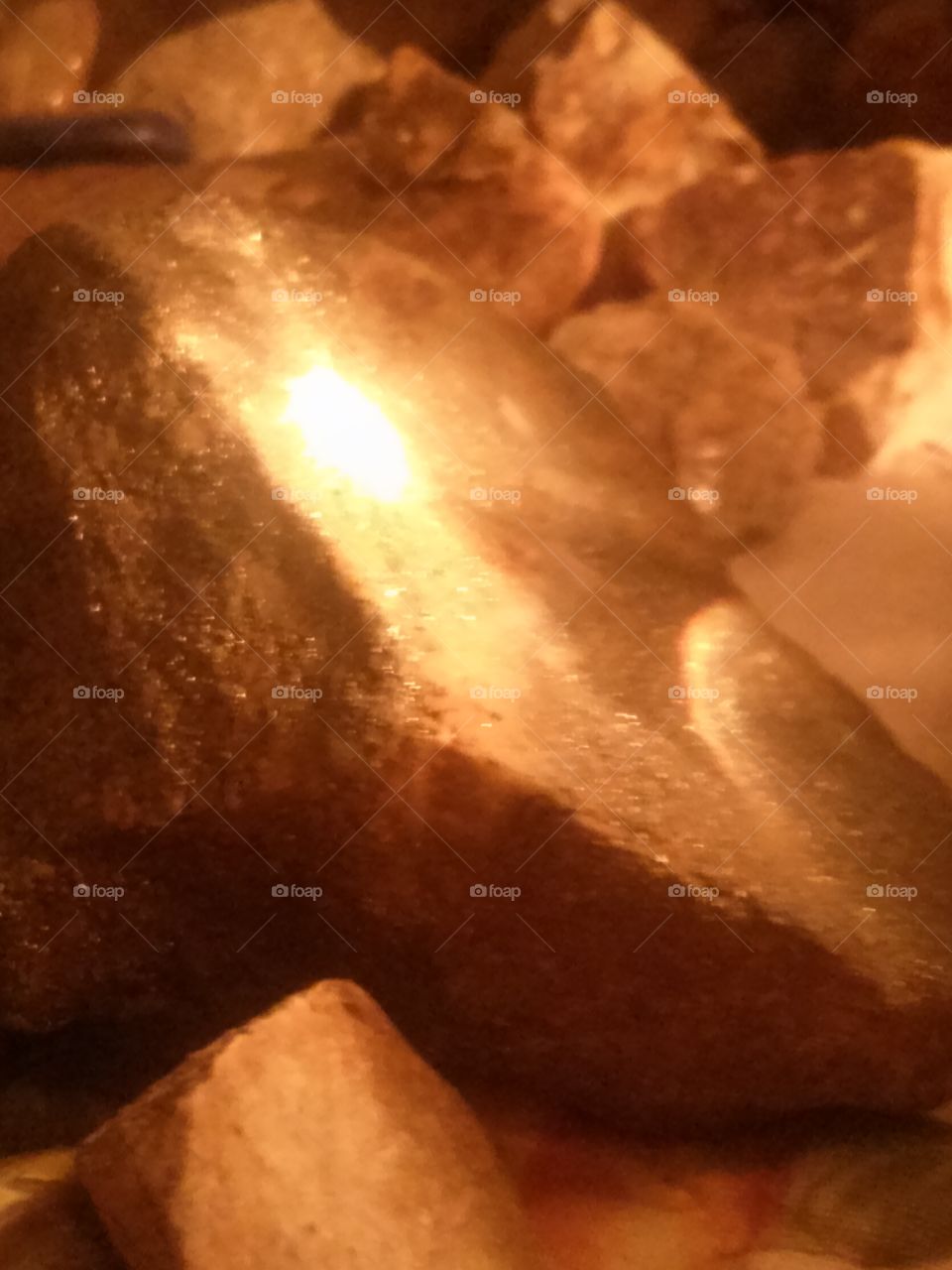 ROCKS A GLOW 
When one is bored and looks
For something to do. 
I start looking at my Rocks,
I don't know bout you ? 
I have collected Rocks 
For years, since I was ten
I used a shoebox at first
Until my collection grew 
Now I have so many Rocks 
My husband says, " Dee, does 
Your Rocks have to be 
In our Room too"? 
Well  any who ,one night
While looking at my Rocks,
My lamp was on and thru 
My Snowglobe shined an
Illuminating glow upon some
Of my Glistening Stones that 
Gave the Picture above.  And 
Made my eyes glow and 
My mouth said " Oh...Whoa"!
How Cool of a thing this is !!
I definately need to snap 
A picture of this.  And so this
Is the picture of the Glowing 
Rocks , and , what I do when
I get bored.  To which, by the 
Way , is not too very often . 
Because I am hardly ever, 
Ever......what is the word? Bored.

I had my lamp on and noticed 
The light shining thru 
My Snowglobe