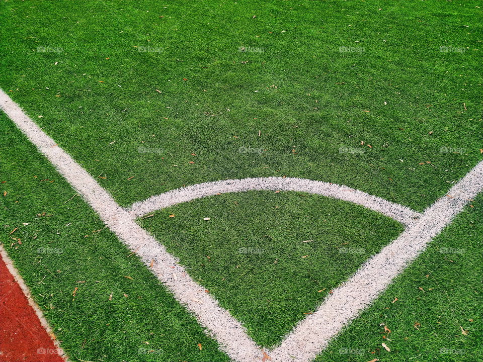 white markings on the green grass of a football field