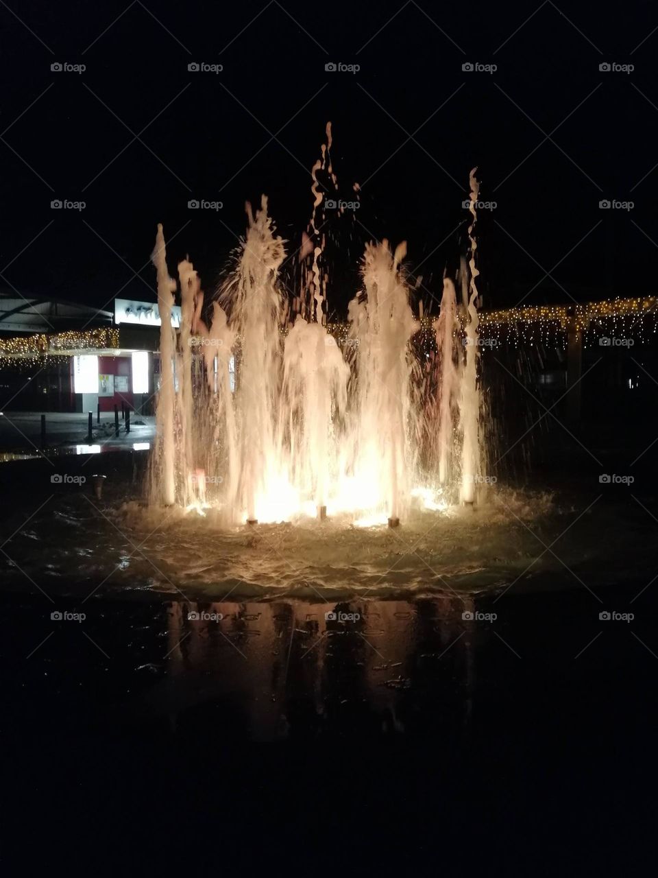 Water fountain in Austrian town Bad Schallerbach, illuminated by Christmas