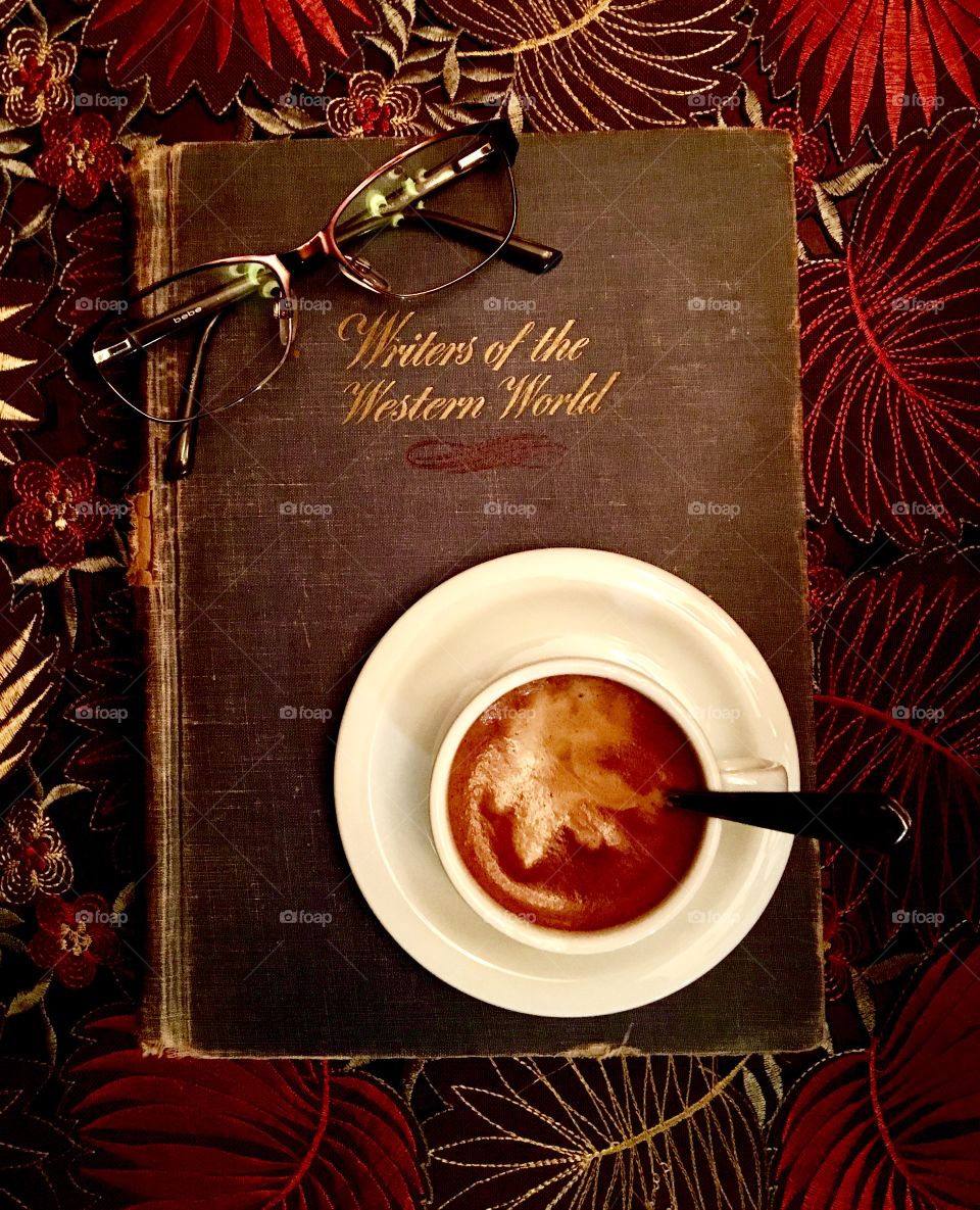 High angle view of cup of coffee with diary