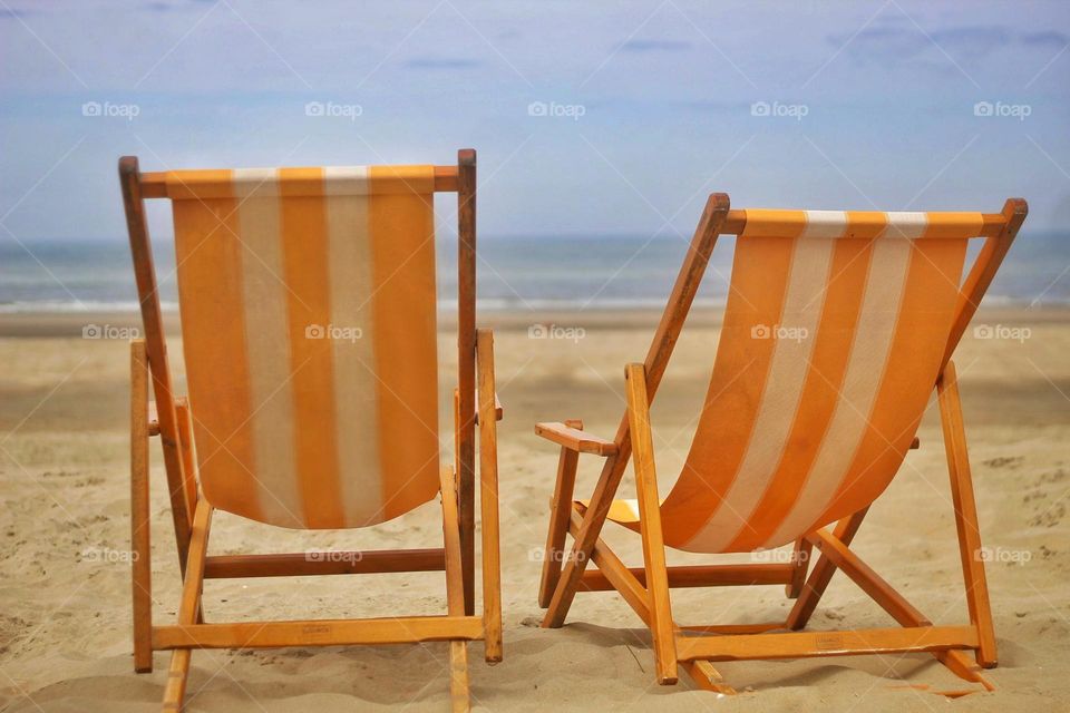 2 orange deck chairs
