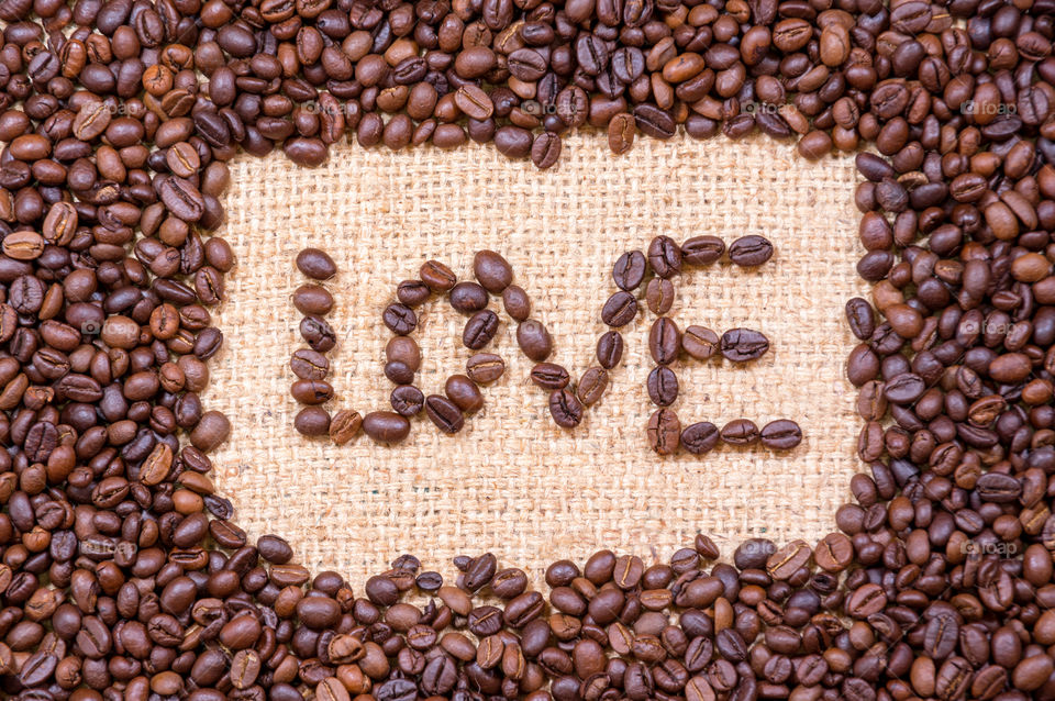 Love word and many coffee beans background