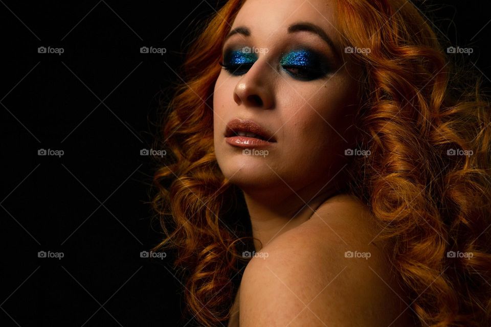 Blue glitter make up on a ginger model