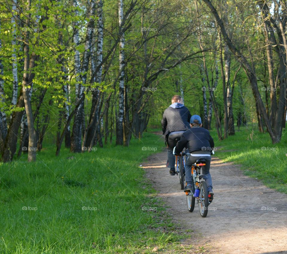 family riding bikes spring time