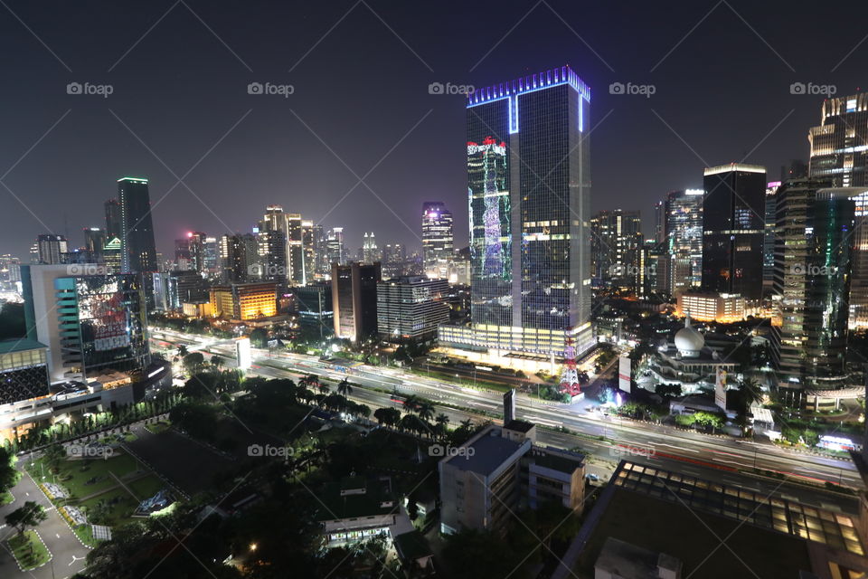 View of Jakarta, Indonesia by night, with traffic flowing along Jl. Gatot Subroto, part of the city's inner ringroad.