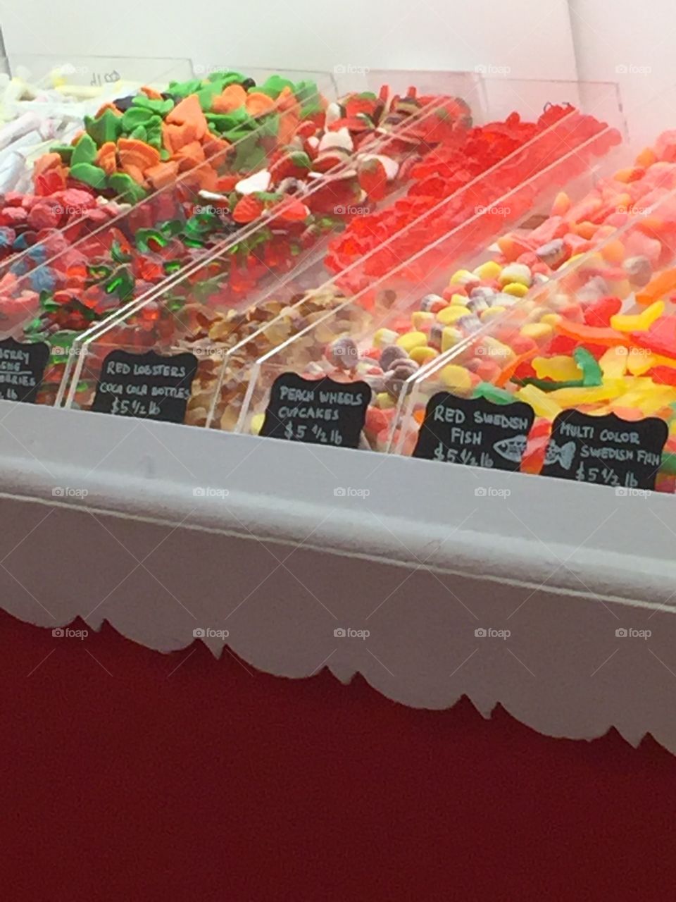 Many rows of colorful candy displayed in a fun candy shop. 