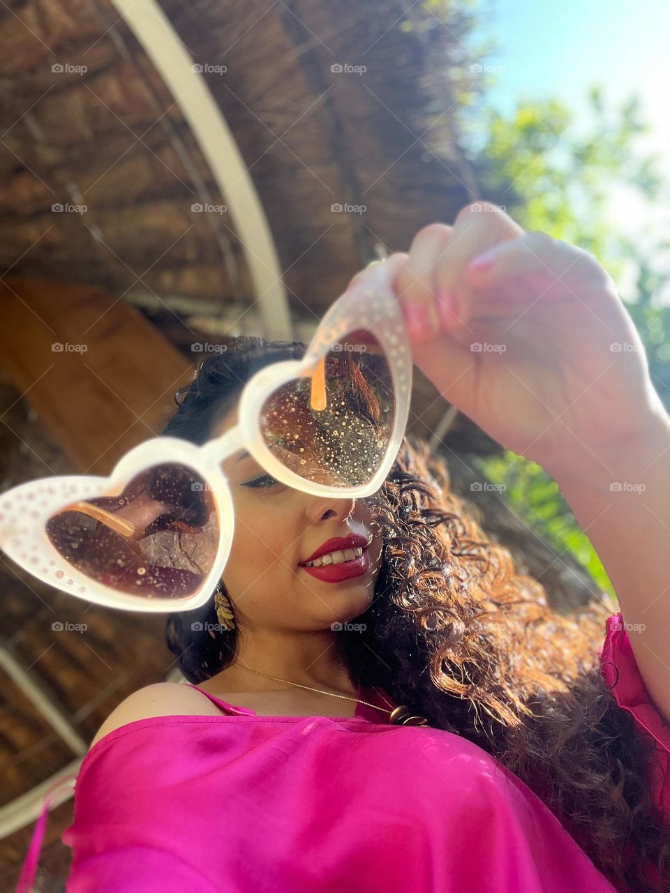 Curly haired girl with heart shaped sunglasses