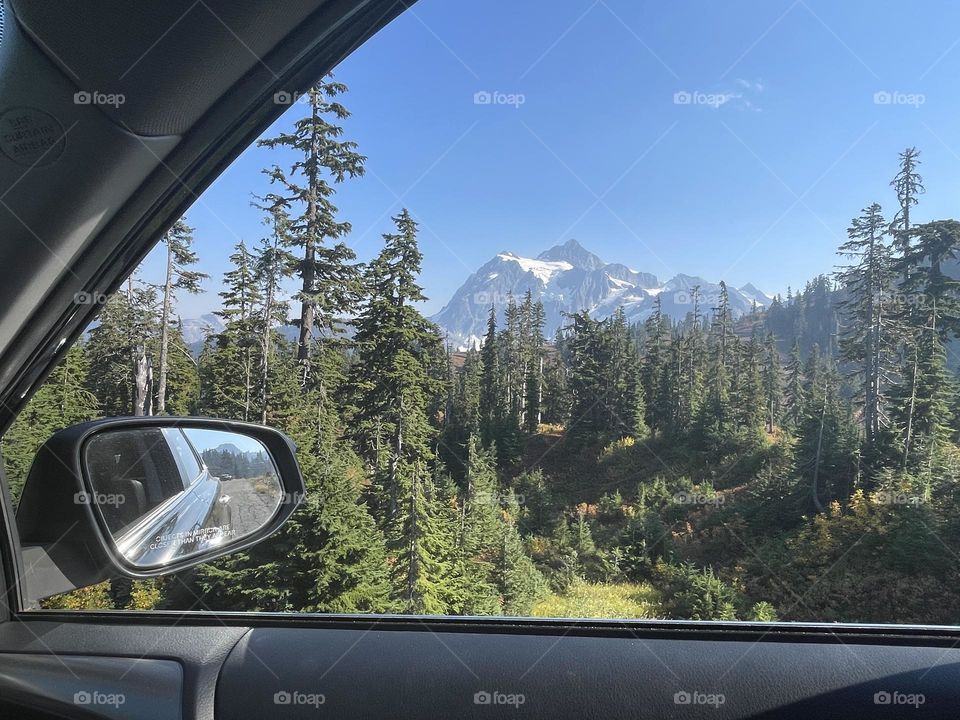 View from car window to the mountains with snow 