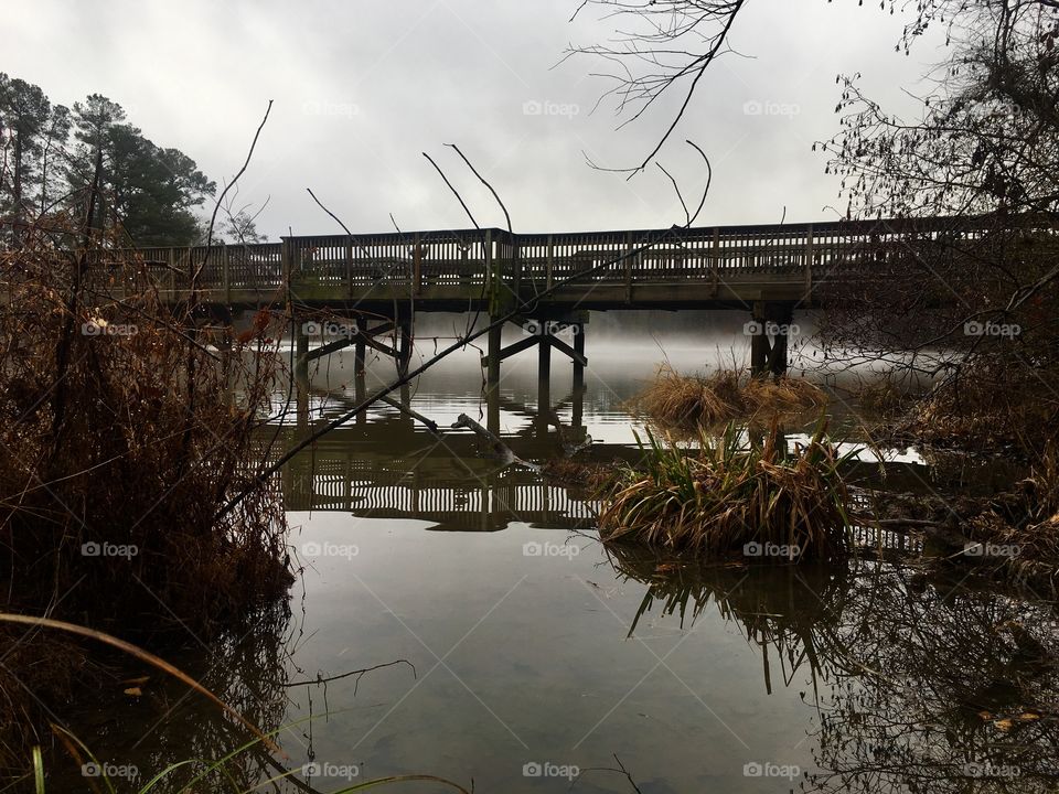 Old wooden bridge on a dreary morning 
